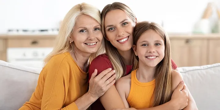 Three generations of women smiling together